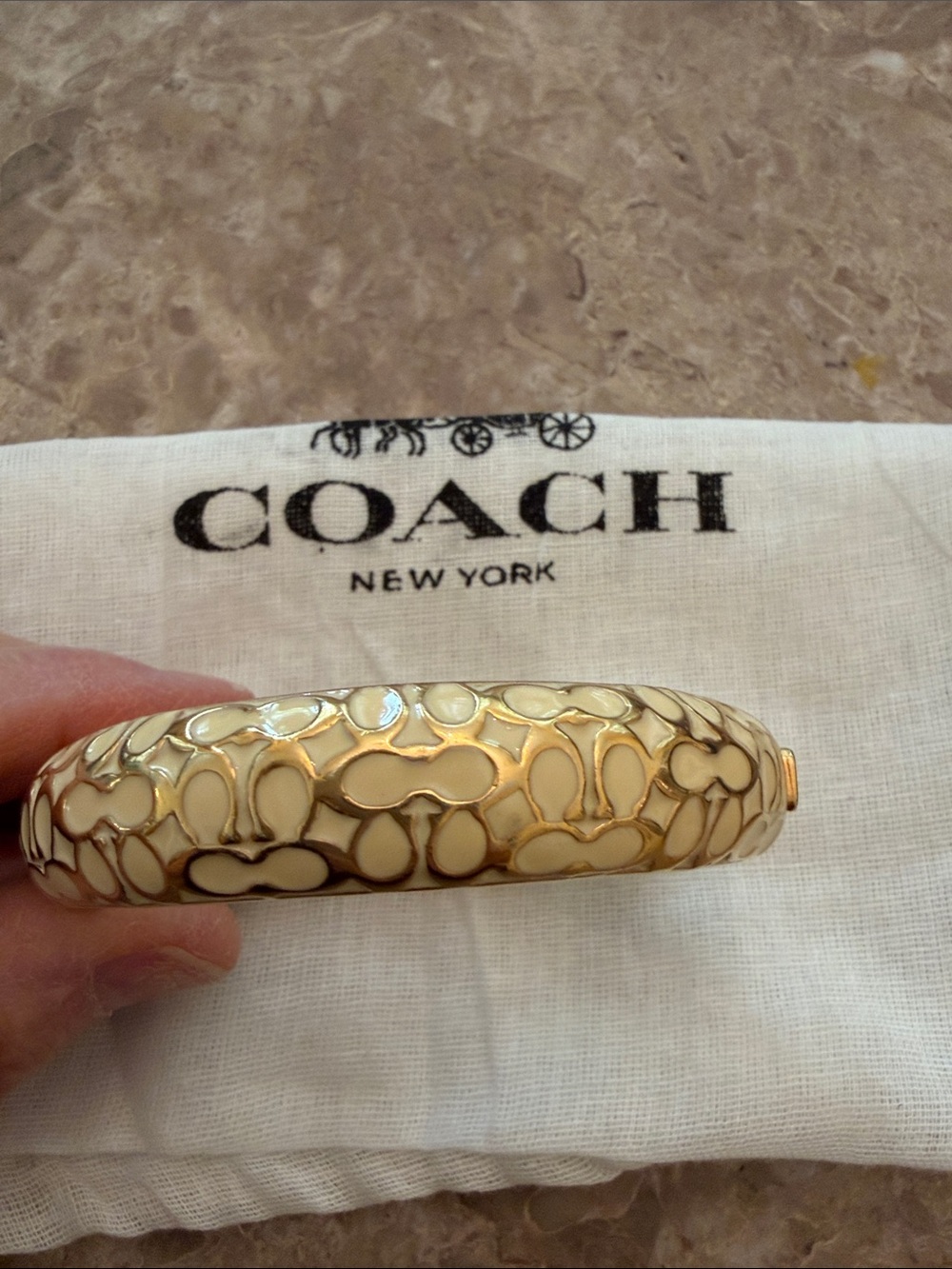 Coach Gold-Tone Bangle with Cream Enamel Pattern with mini coach tag